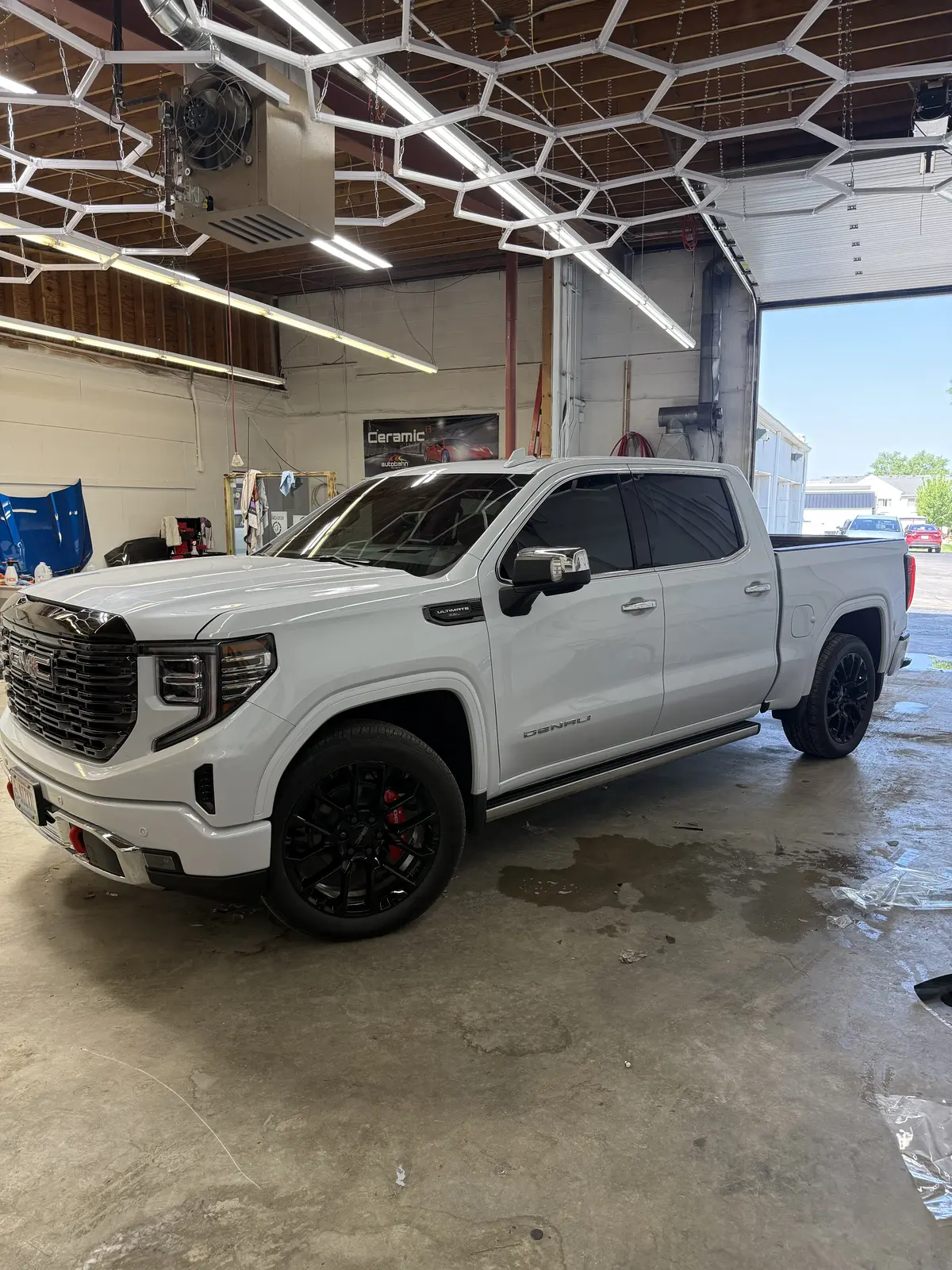 White pickup truck window tint installation inside the Quincy shop